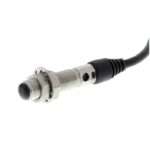 Inductive proximity sensor with a threaded metal body and attached cable for mounting in equipment