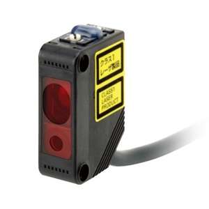 Photoelectric sensor module with a red optical window and a yellow Class 1 Laser Product label, connected to a gray cable.
