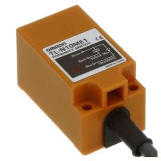 Orange Omron proximity switch module with black wiring attached (close-up).