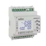 White Selec digital energy meter module (MFM384-R-C) with blue backlit display showing electrical parameters; green terminal blocks on top and bottom for connections, used to monitor voltage, current, and power in a control panel.